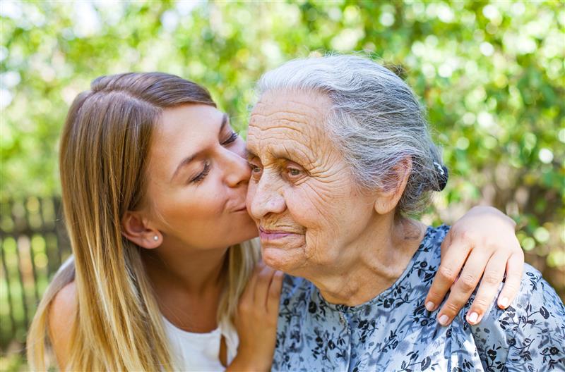 A woman caring for her mother as an example of adult foster care.