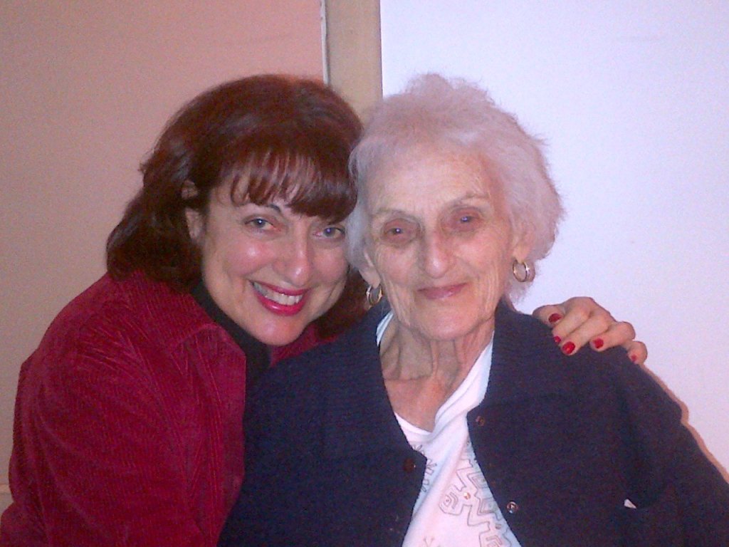 A caregiver daughter smiling with her elderly mother