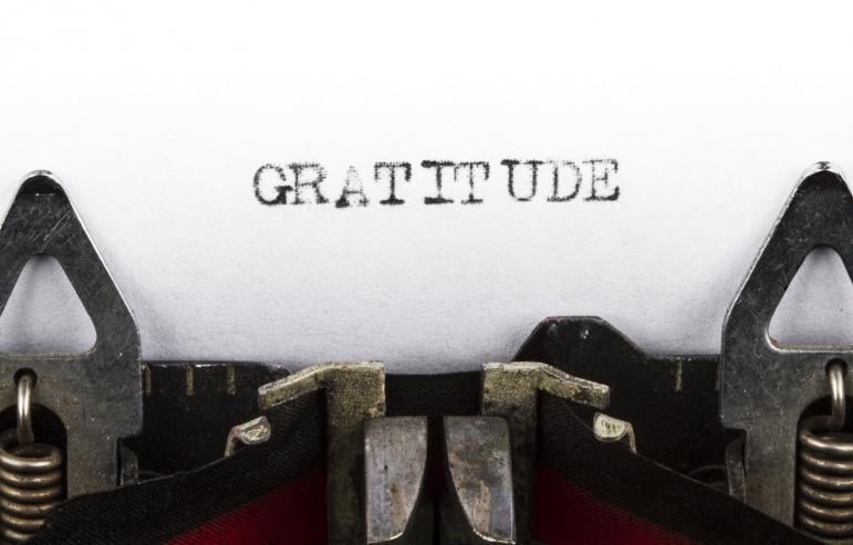 The word "gratitude" written on a typewriter