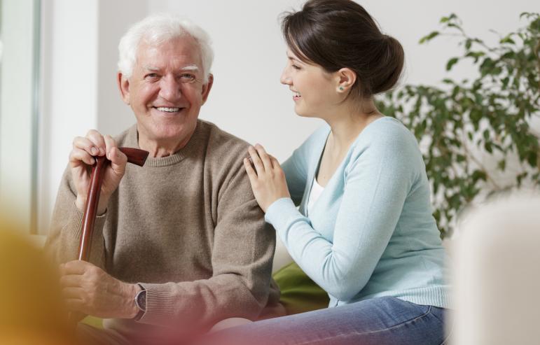 A caregiver holding their loved one's shoulder, conveying the significance of compassionate support in caregiving