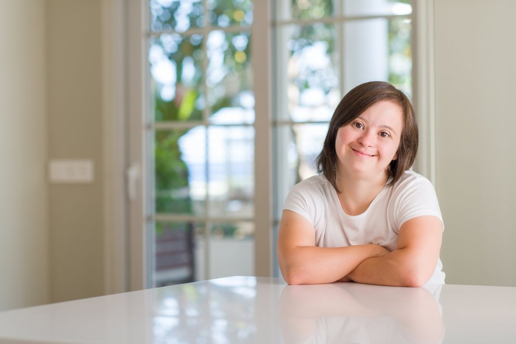 An image of a smiling younger disabled woman