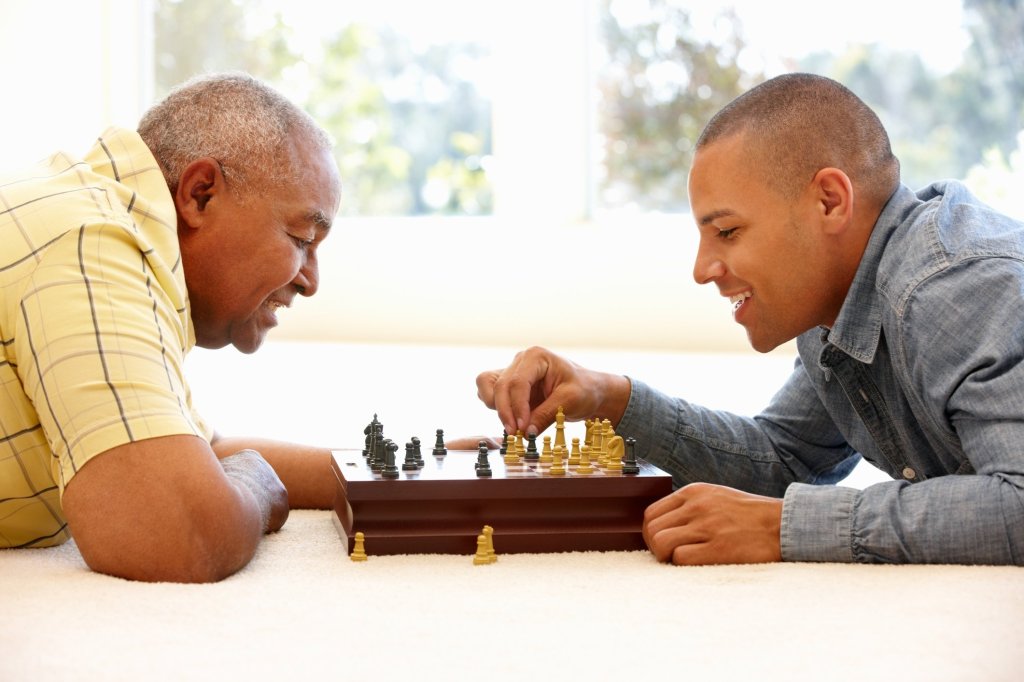 Two men playing chess, fostering mental stimulation and connection for loved ones