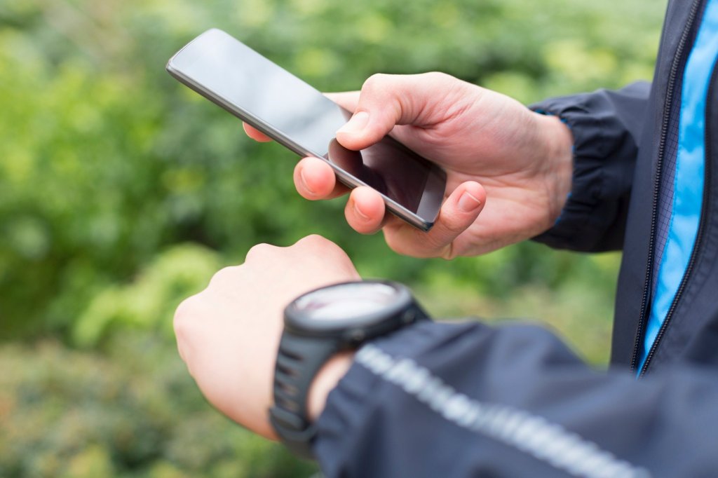 A man using a GPS tracker to safeguard the well-being of an elderly loved one