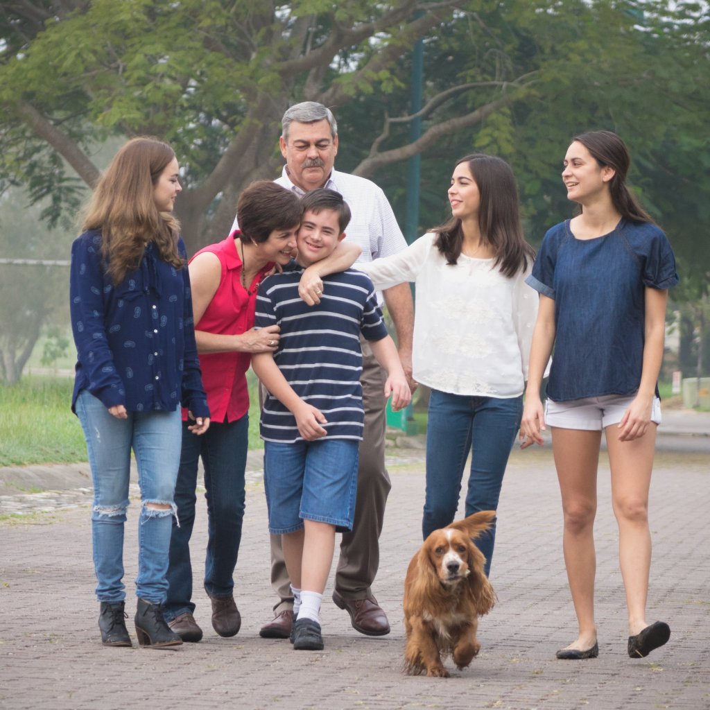 A young disabled boy taking a walk with his caregiving family