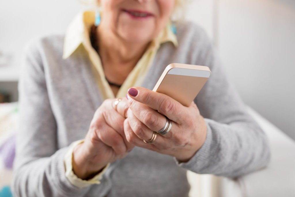 An elderly woman using a smartphone