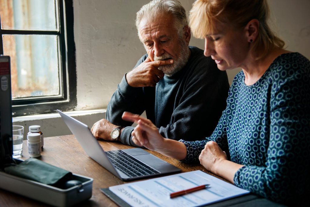 A couple looking online for caregiving support