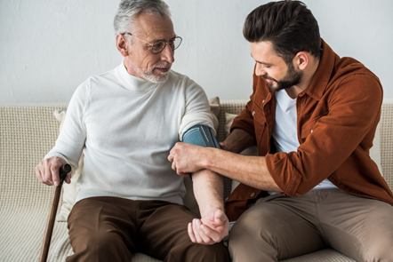 Caregiver attentively taking their patient's blood pressure