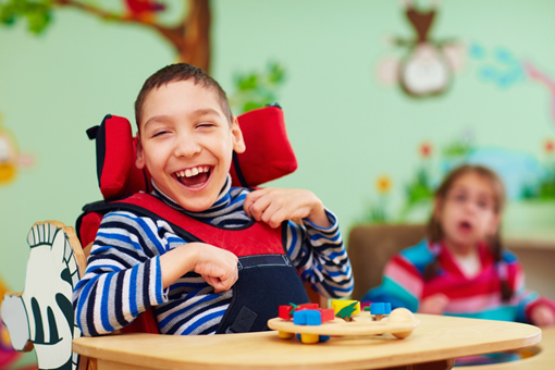 A smiling child with disabilities radiating joy and resilience