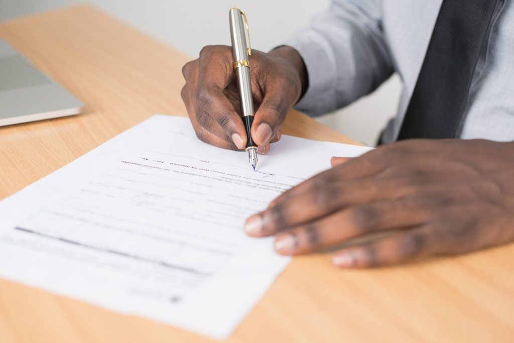 A caregiver filling out legal paperwork