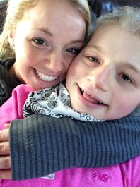 A caregiver smiling with her sister who has angelman syndrome