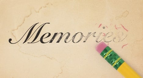 A pencil erasing the word "memories" on a piece of paper