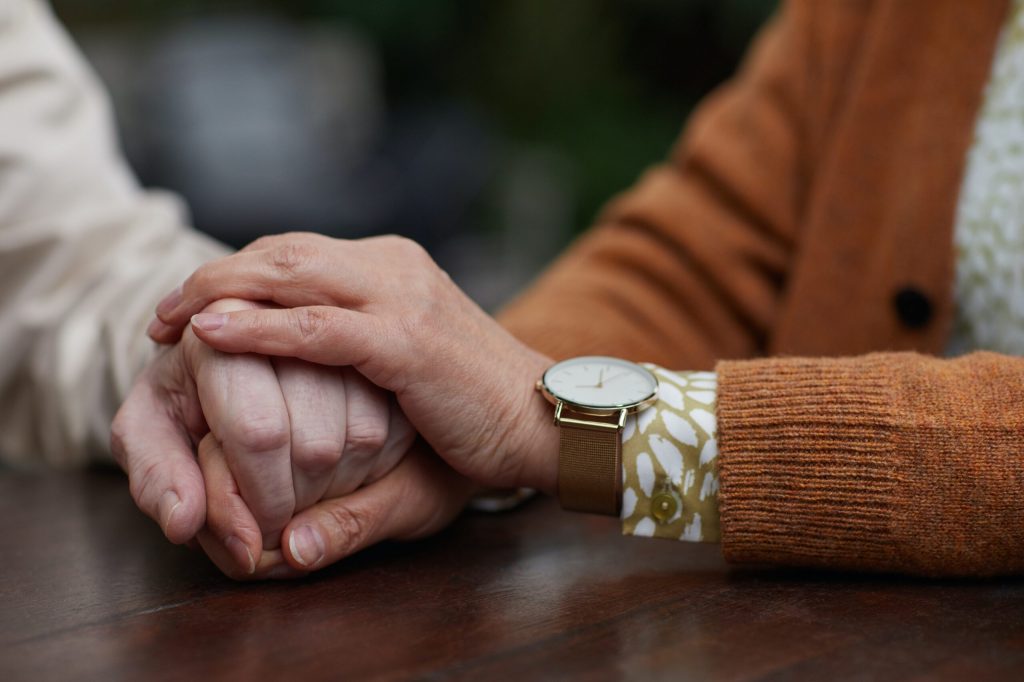 clasping hands for end of life care