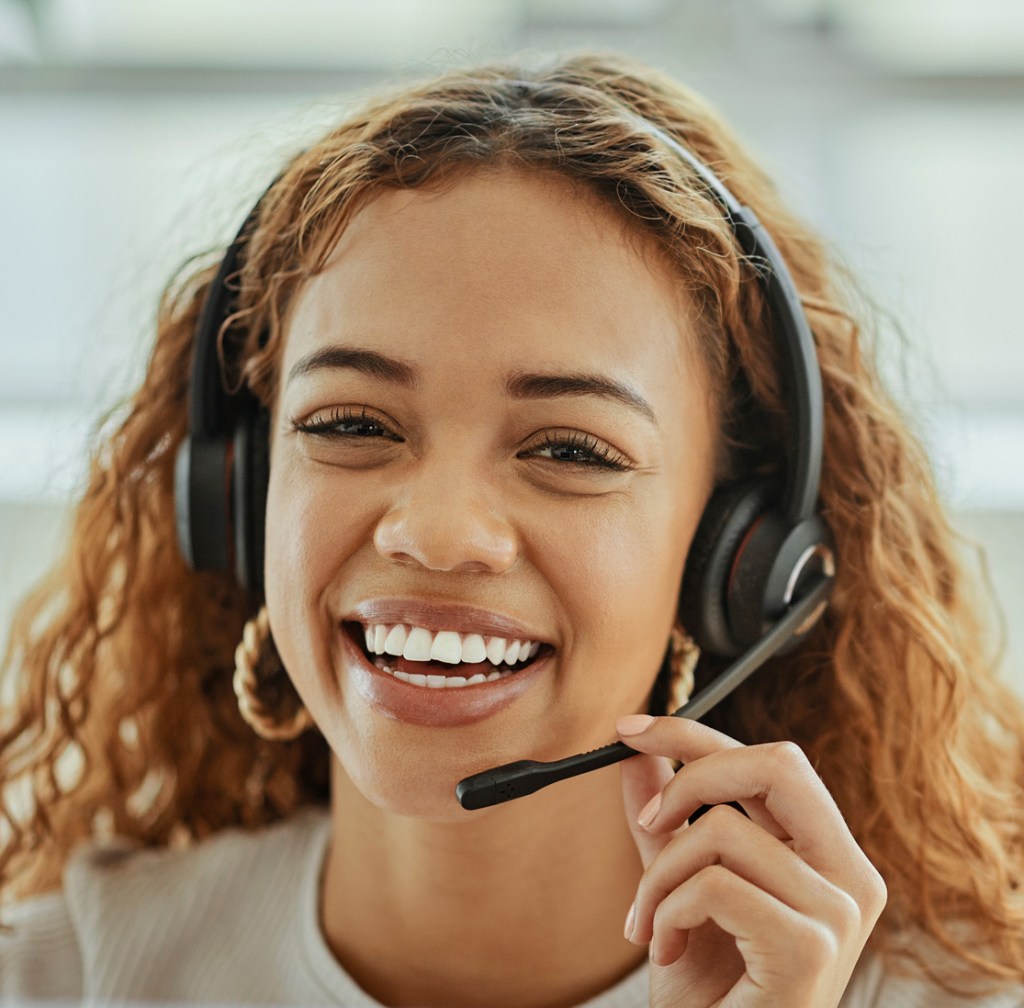 An image of a friendly lady with a headset.