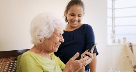 stockfresh_8217002_girl-helps-old-woman-using-mobile-phone-and-technology_sizeXS (1)-min.jpg