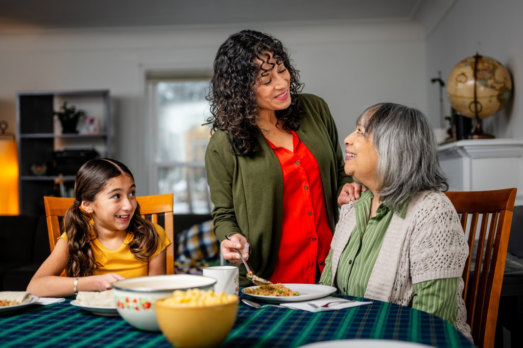 A caregiver providing support to her mother and daughter.