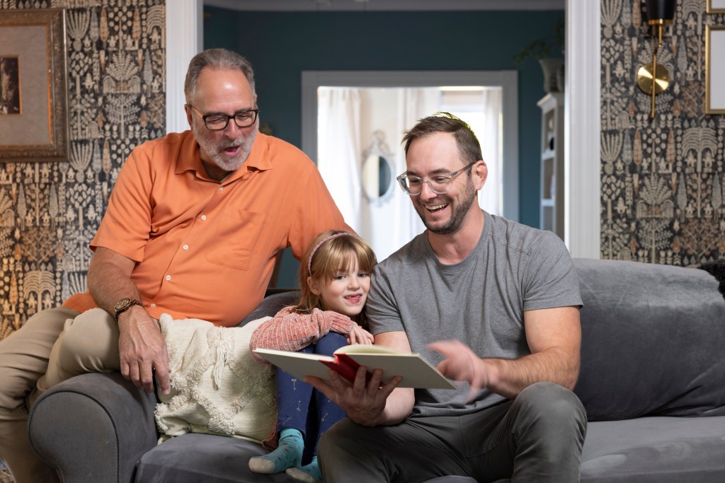 A family (including caregiver and loved one) relax together.