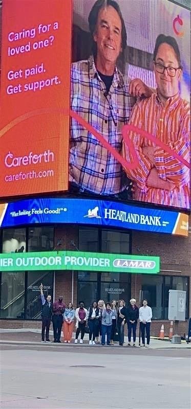 A picture of the Careforth Staff in front of a Careforth billbord.